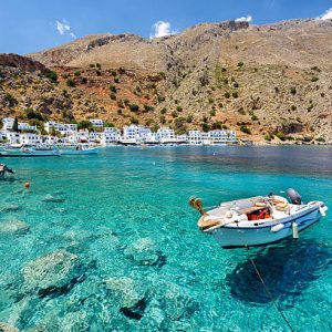 Small motorboat at clear water bay of Loutro town on Crete island, Greece